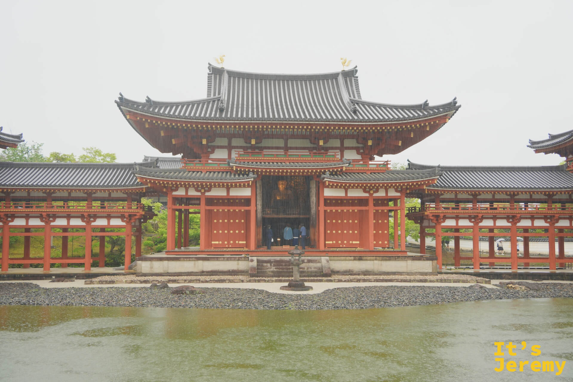 平等院鳳凰堂 正面對稱構圖，左右翼廊展翅如鳳凰，倒影浮現池面