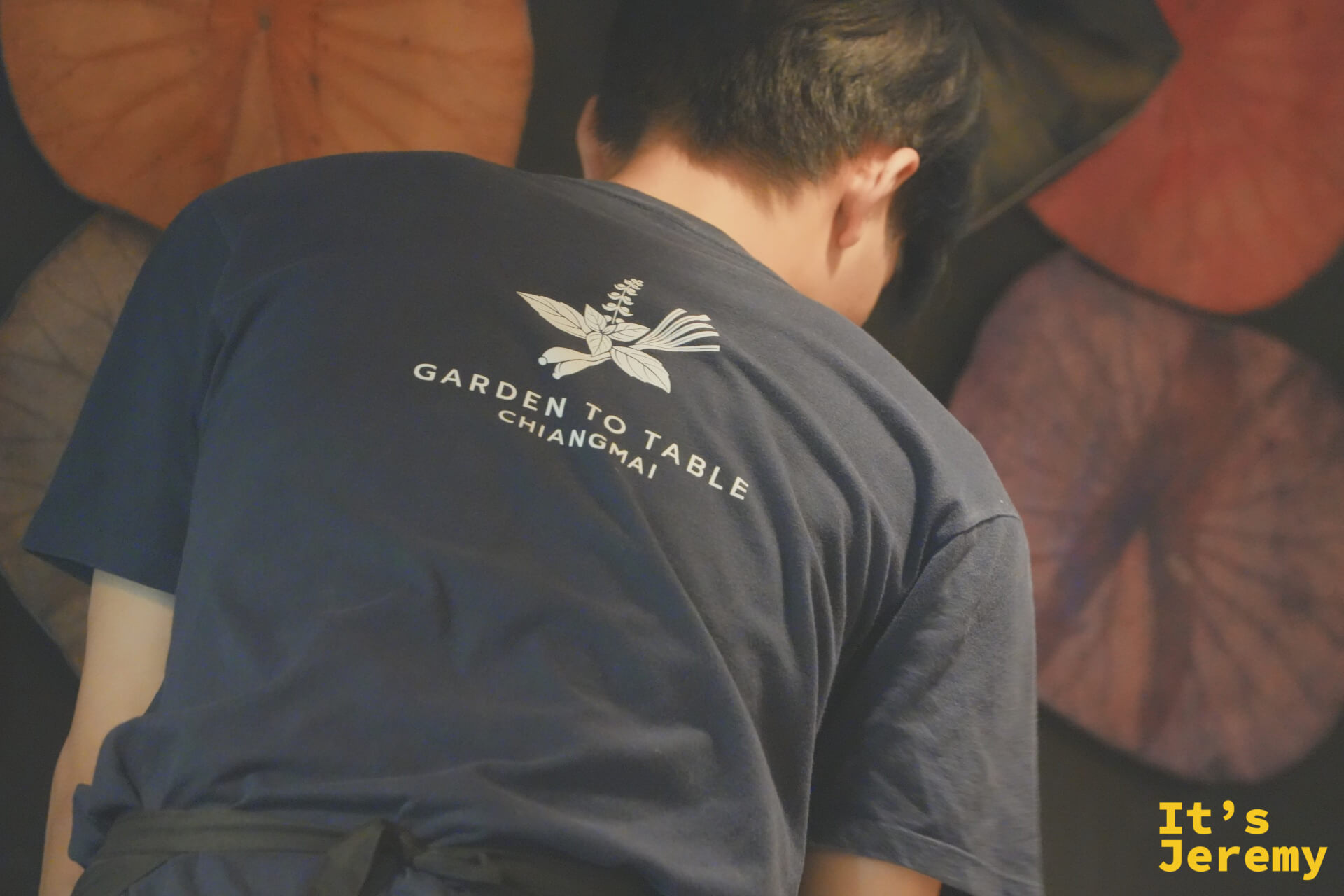 工作人員身著印有 Garden to Table Chiangmai 標誌的深藍制服