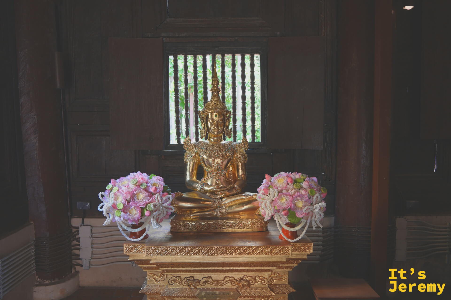 另一側龕金身坐佛，坐於金色台座，木格窗光線柔和