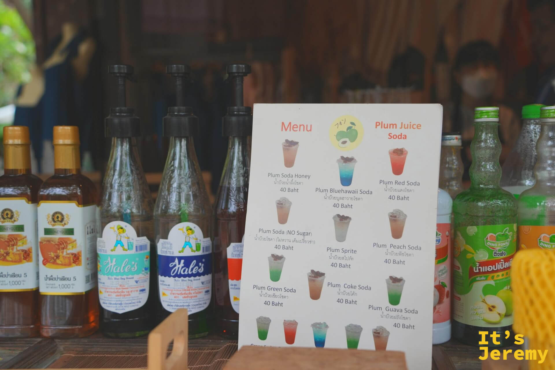 Plum Juice Soda 菜單立牌,列出蜂蜜、藍色夏威夷、紅蘇打等口味,每杯 40 泰銖