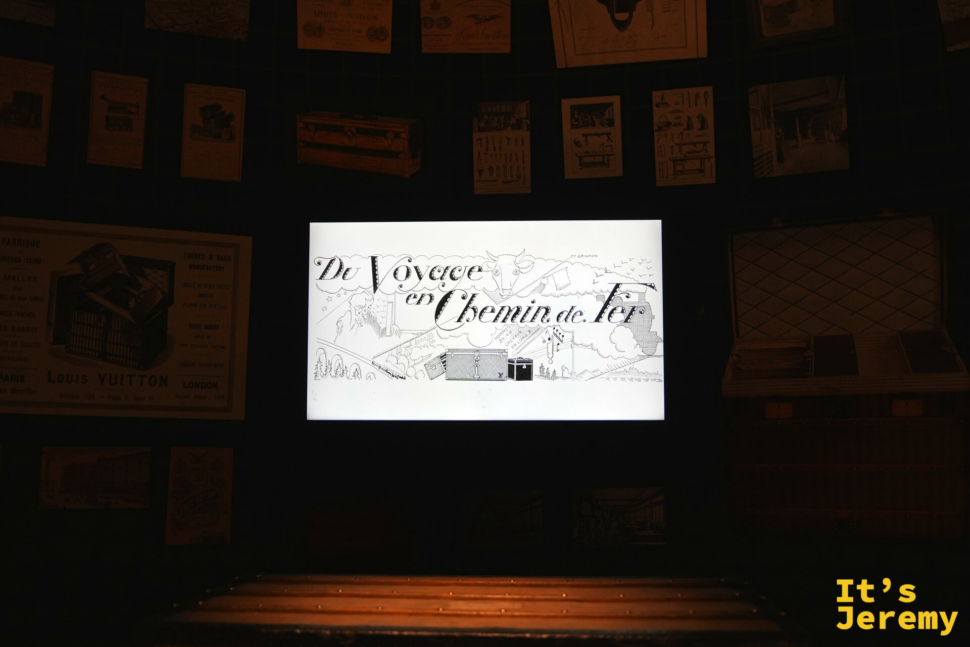 歷史展區螢幕播放《Du Voyage en Chemin de Fer》手繪動畫，周圍貼滿 LV 各年代廣告海報與設計圖