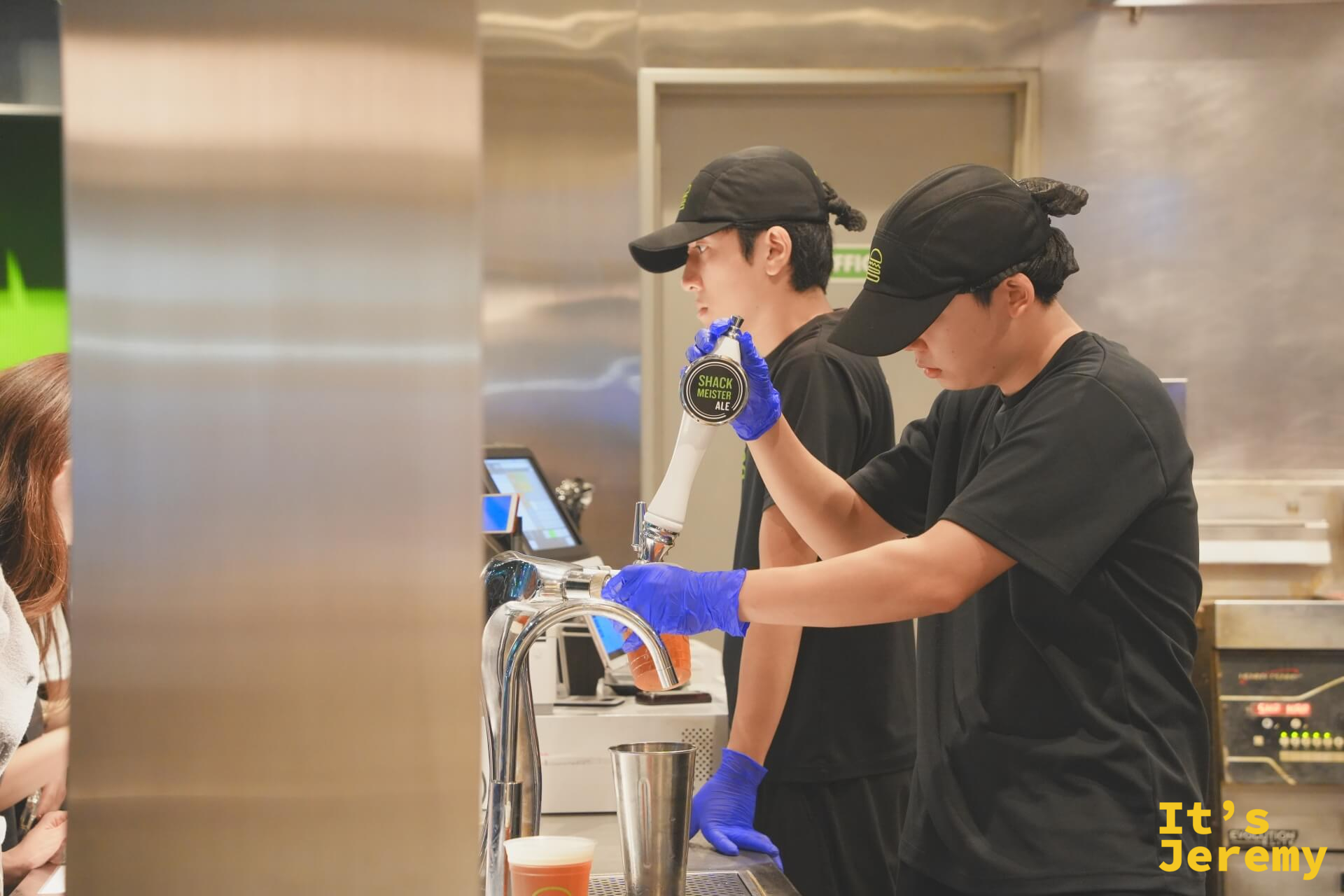 店員操作 Shack Meister Ale 生啤機，啤酒龍頭上清楚寫著品牌名稱