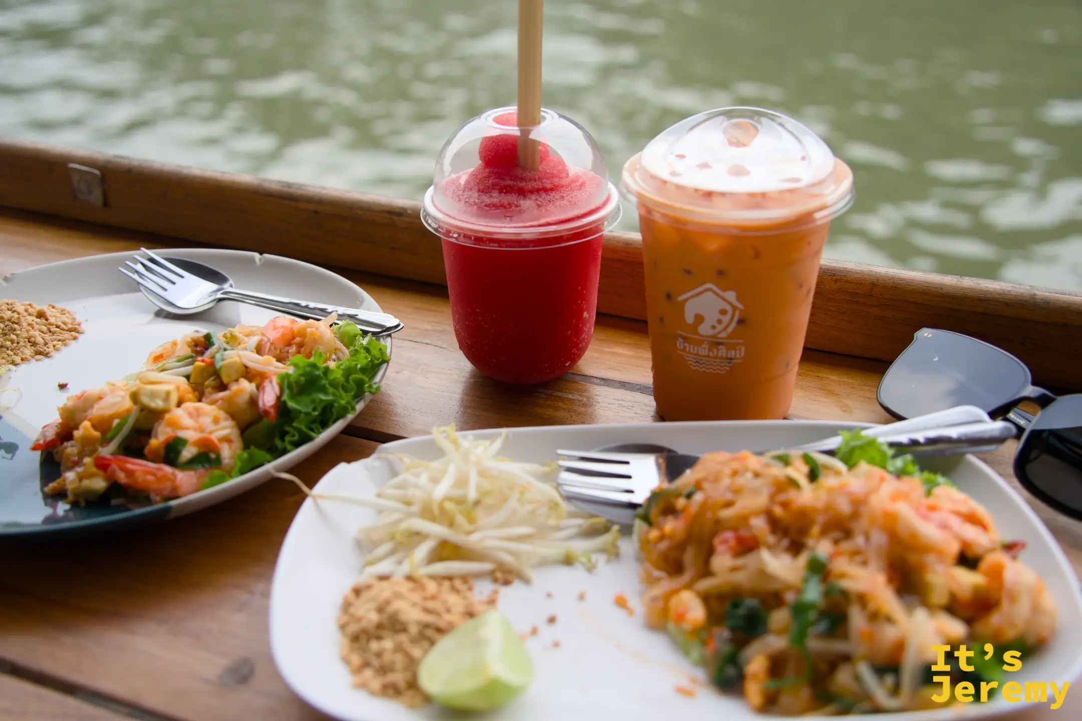 木棧台上的早午餐桌景：招牌 Pad Thai、蝦子沙拉、泰式奶茶，腳下就是 Khlong Bang Luang 運河