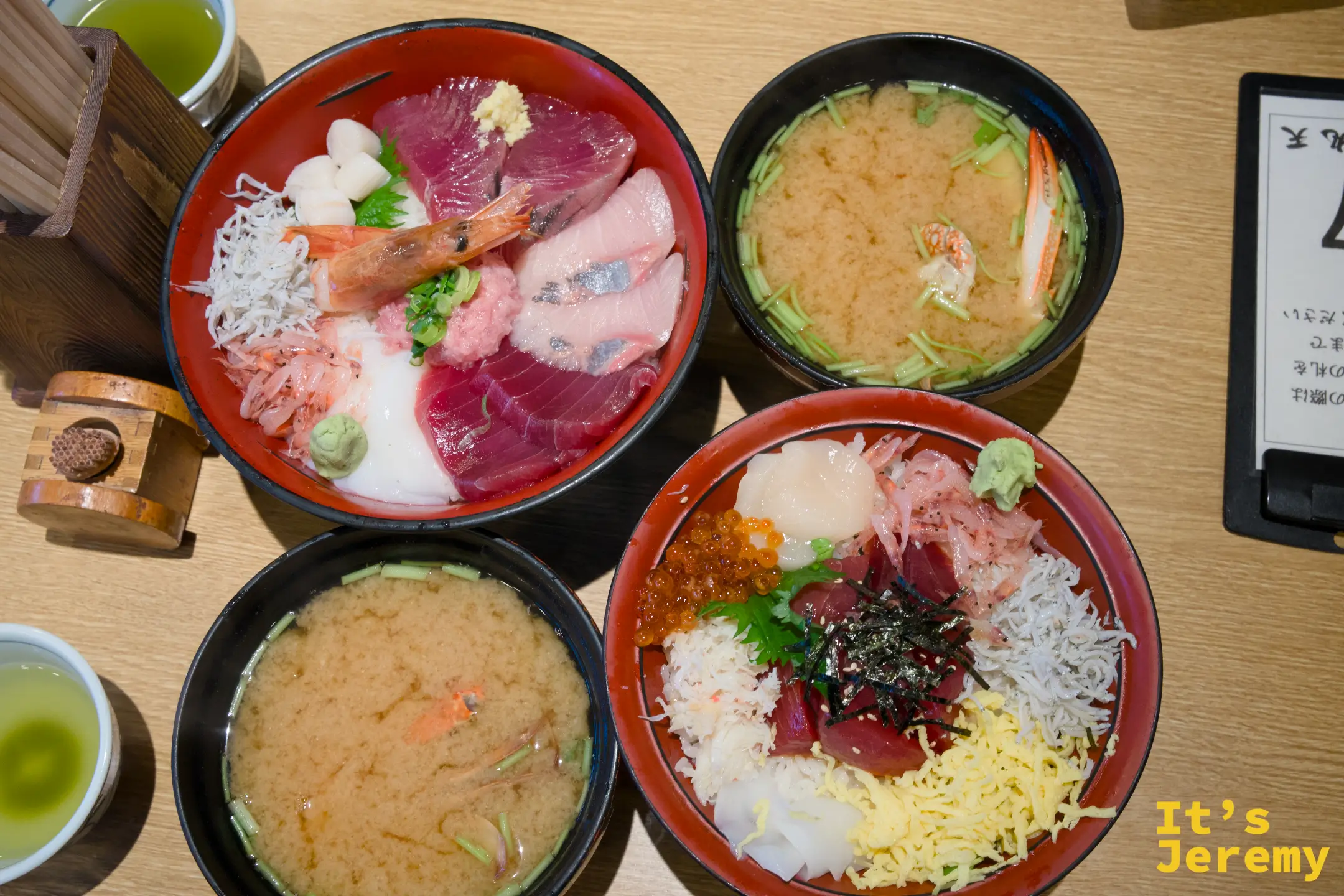 從上方俯瞰兩碗海鮮丼和兩碗蟹味噌湯，用料豐盛