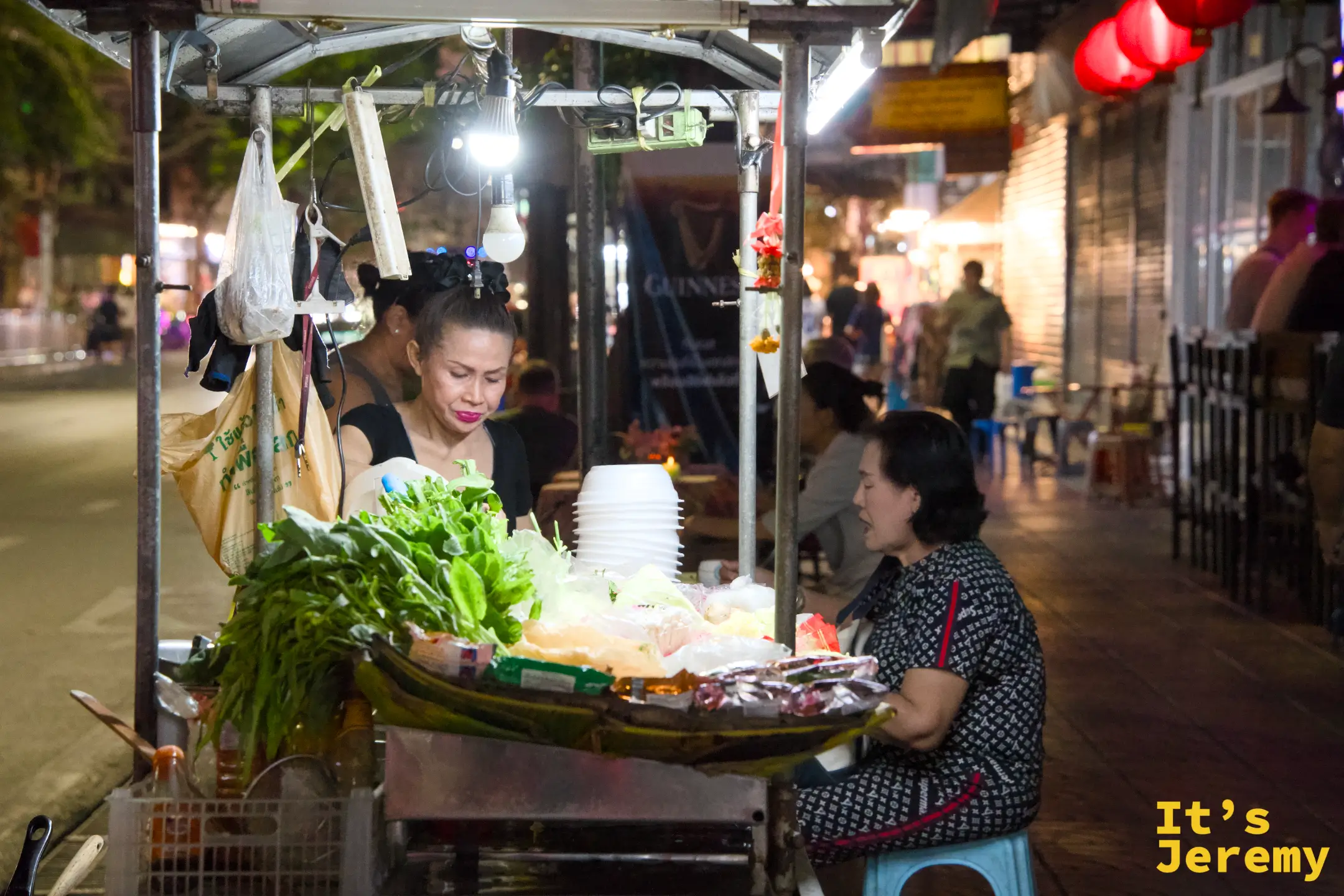 唐人街街邊小販與正在低頭專心吃飯的食客