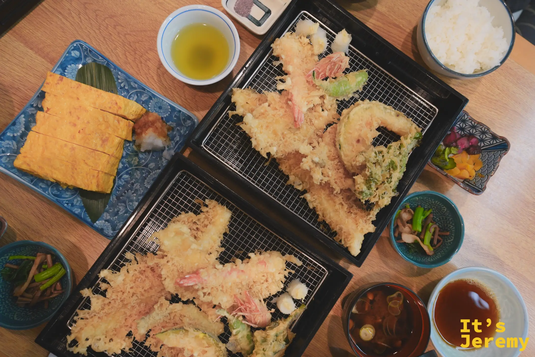 從上方俯視葵丸進桌面，兩份天婦羅套餐、玉子燒、小菜、茶與沾醬整齊排列