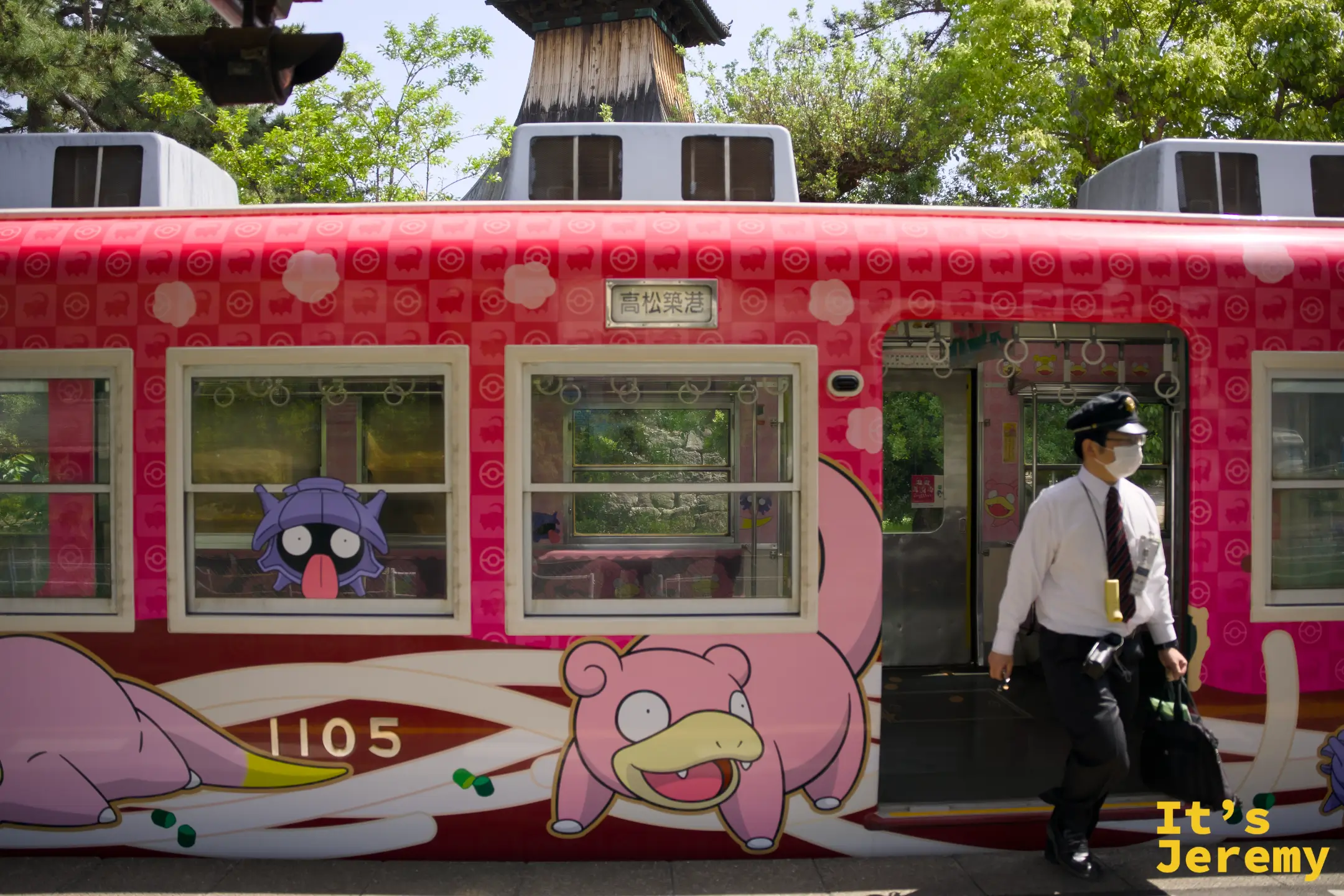 呆呆獸列車側面車身，呆呆獸和其他寶可夢繪在車廂外牆，背景隱約可見傳統木造站房屋簷