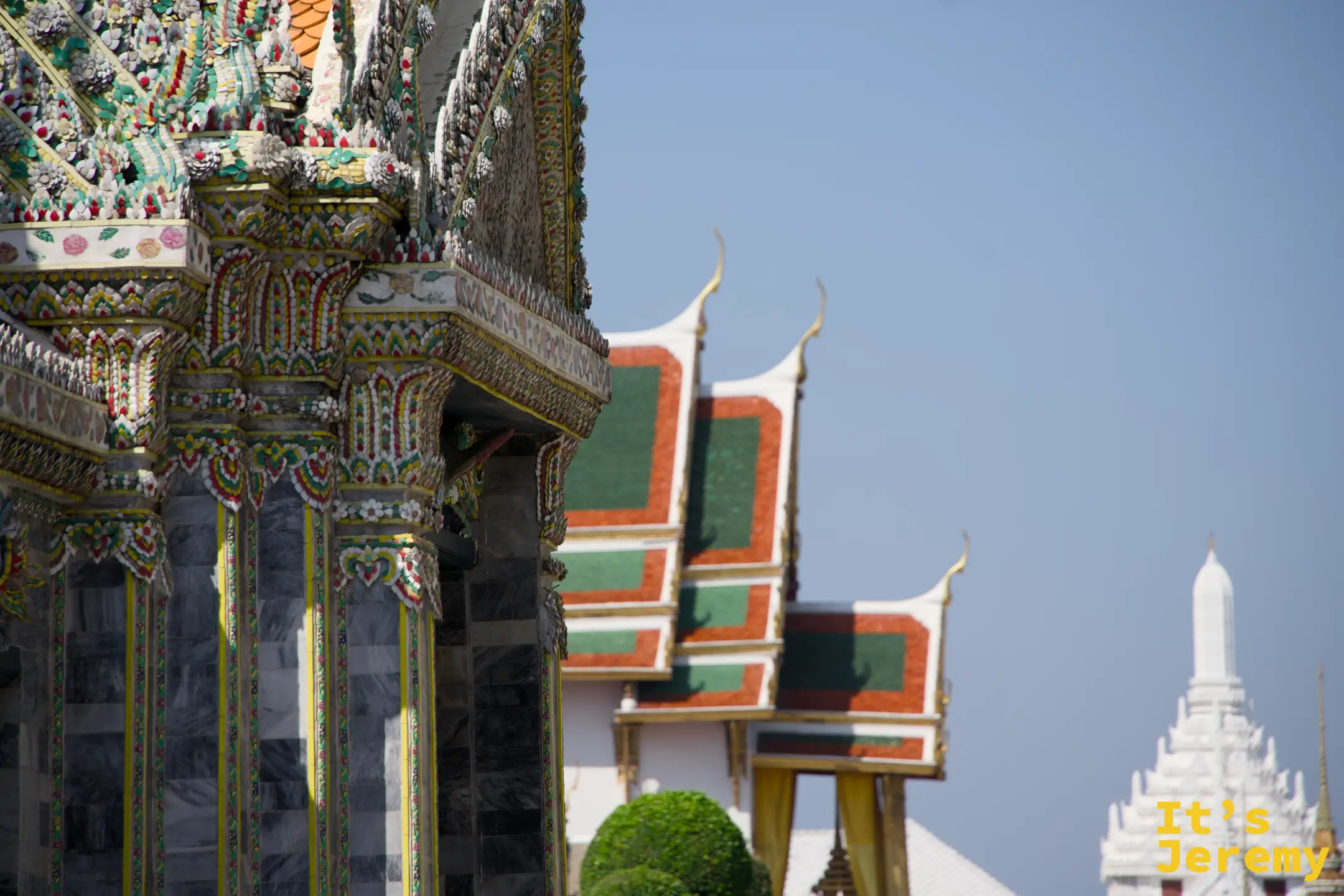 中宮區建築側面，彩色山牆裝飾與遠方白色 Prasat 塔