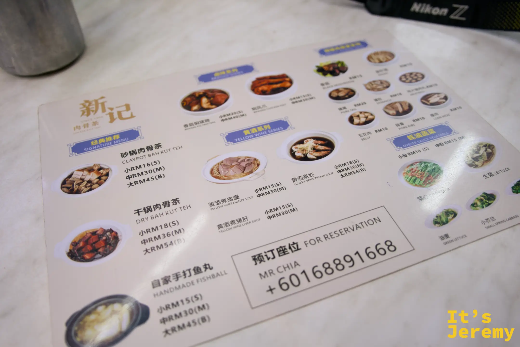新記菜單，分砂鍋肉骨茶、干鍋肉骨茶、黃酒系列、牡蠣醬蔬菜類，附照片與價格，右下方有訂位電話