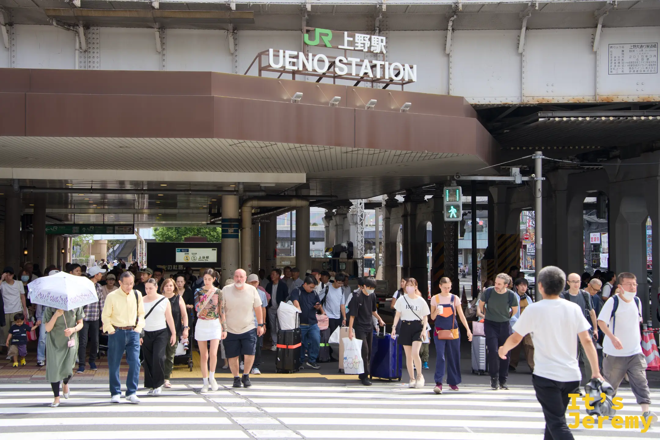 JR 上野駅入口,大批旅人與通勤族從出口湧出,行李箱與大背包交錯