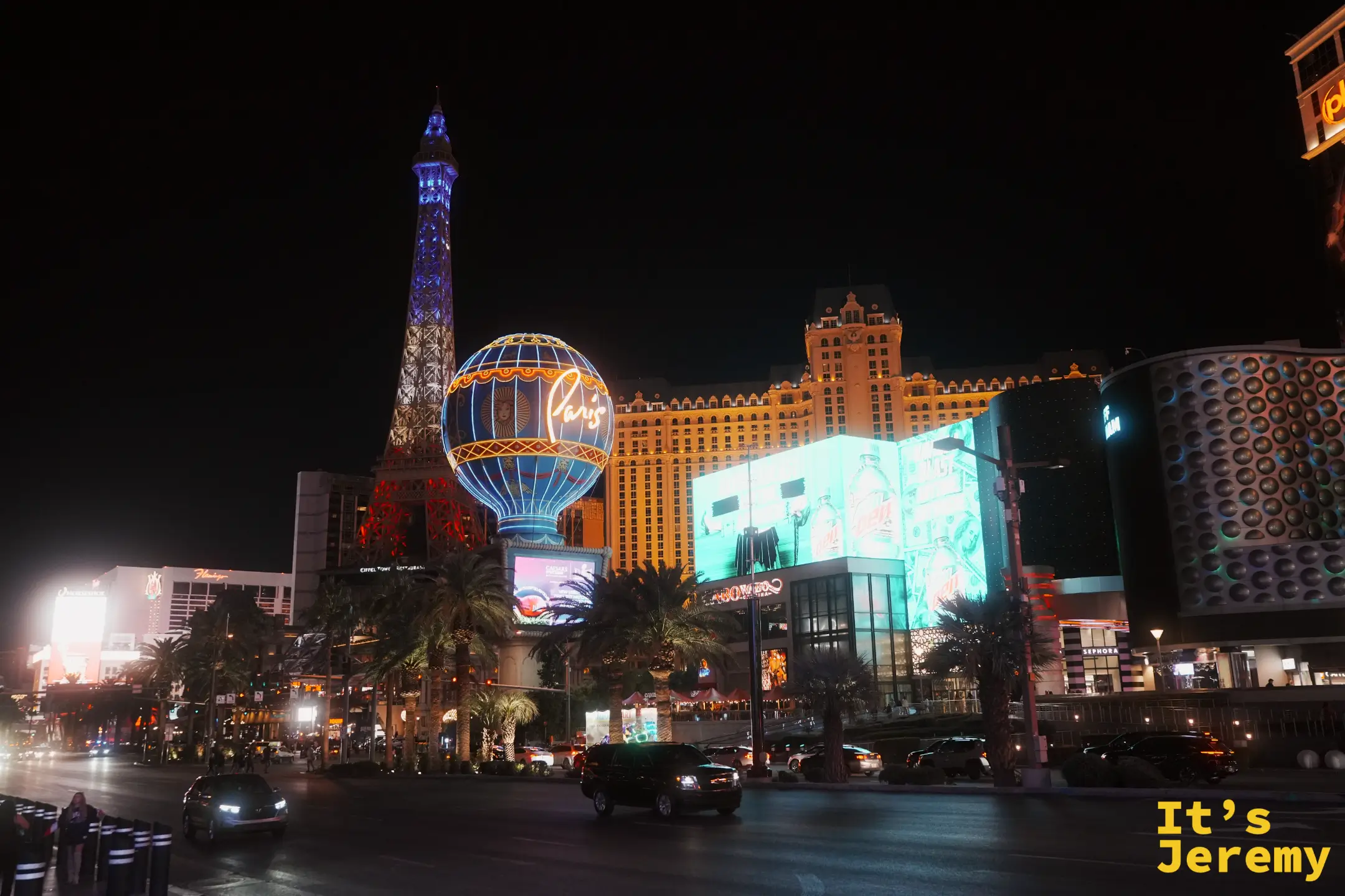 Paris Las Vegas 的半座艾菲爾鐵塔亮起藍白燈，旁邊是寫著 Paris 的熱氣球招牌