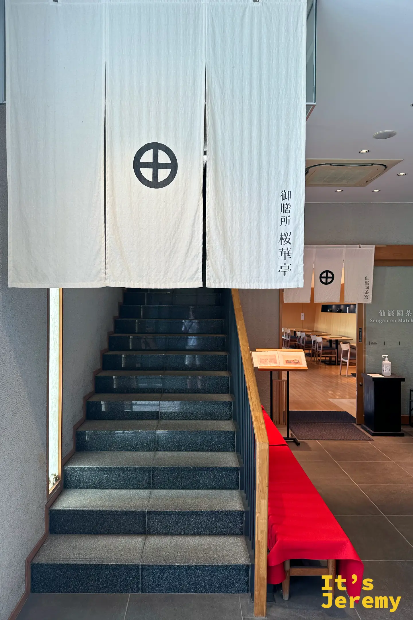 御膳所 桜華亭門口的白色暖簾，印著島津家紋「丸に十字」，旁邊是仙巌園茶寮