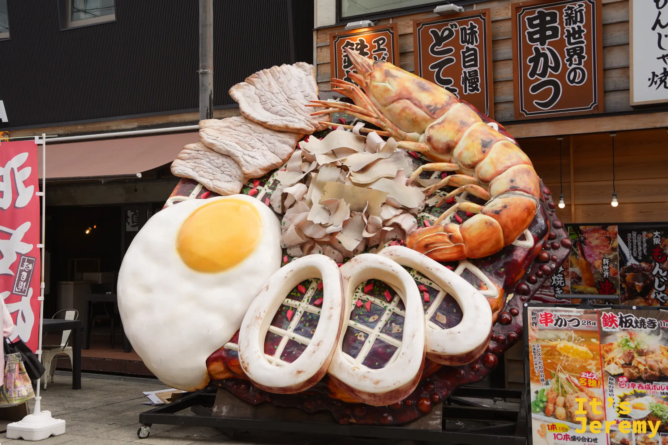店門口比人還大的鐵板燒模型，有荷包蛋、蝦子與魷魚圈